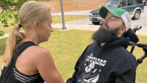 Jane Hart of Modified Ability Yoga guides a student in a wheelchair through adaptive yoga in Greenville, SC